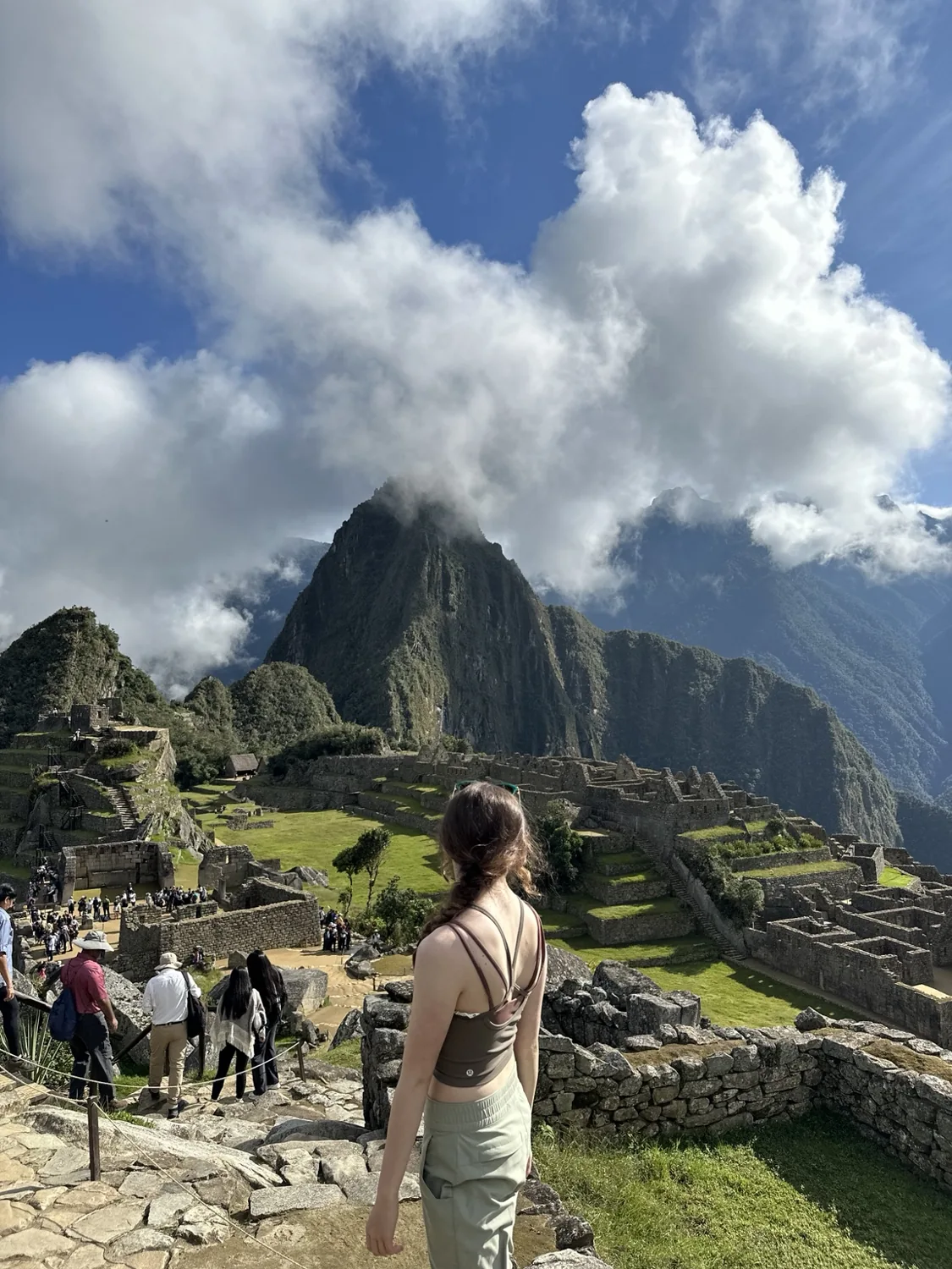 Lyra overlooking the Machu Picchu archaeological site with mountains in the background